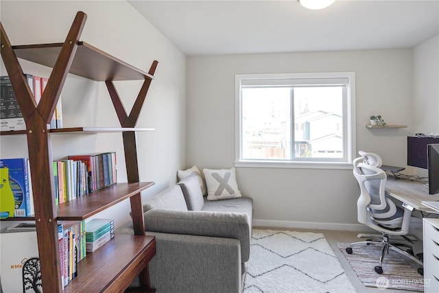 carpeted office featuring baseboards