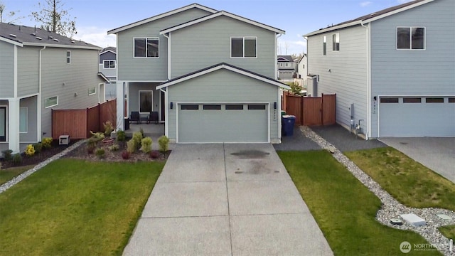 traditional-style house featuring a garage, driveway, a front yard, and fence