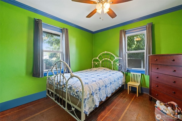 bedroom with ceiling fan, baseboards, wood-type flooring, and ornamental molding