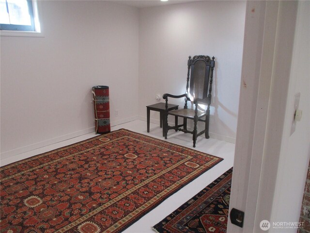 living area featuring baseboards