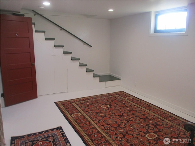 basement featuring stairway and recessed lighting