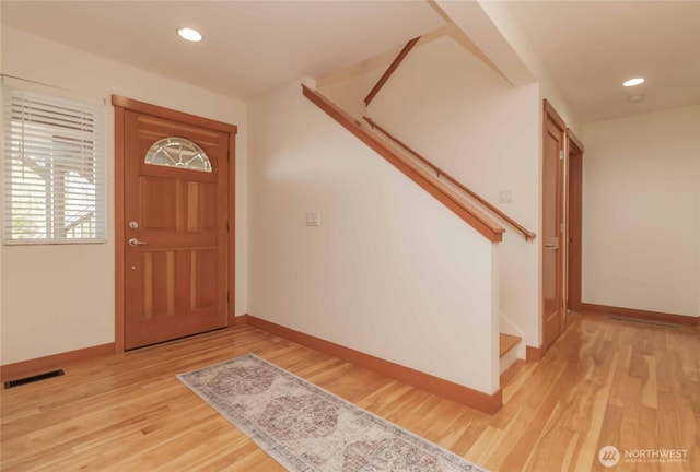 4195 Windy Cove Ln, Clinton, WA 98236 - entryway featuring visible vents, baseboards, light wood-style floors, and stairs