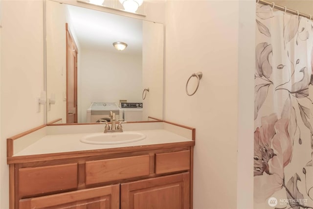4195 Windy Cove Ln, Clinton, WA 98236 - bathroom with a shower with shower curtain, vanity, and washer and clothes dryer