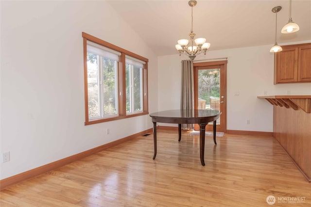 4195 Windy Cove Ln, Clinton, WA 98236 - dining space featuring visible vents, a notable chandelier, baseboards, light wood-style floors, and lofted ceiling