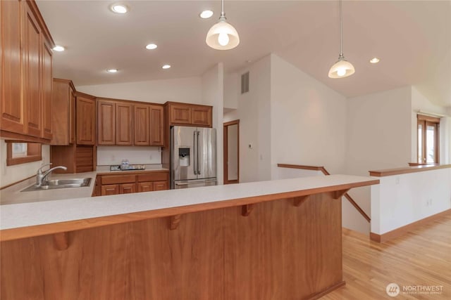 4195 Windy Cove Ln, Clinton, WA 98236 - kitchen featuring visible vents, a peninsula, stainless steel fridge with ice dispenser, a sink, and light countertops