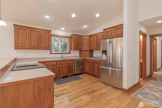 4195 Windy Cove Ln, Clinton, WA 98236 - kitchen featuring light wood-style flooring, a sink, light countertops, appliances with stainless steel finishes, and brown cabinets