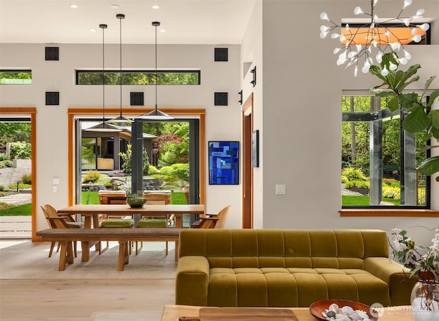 11012 Skinner Rd NE, Bainbridge Island, WA 98110 - living room featuring wood finished floors, a high ceiling, recessed lighting, and a chandelier