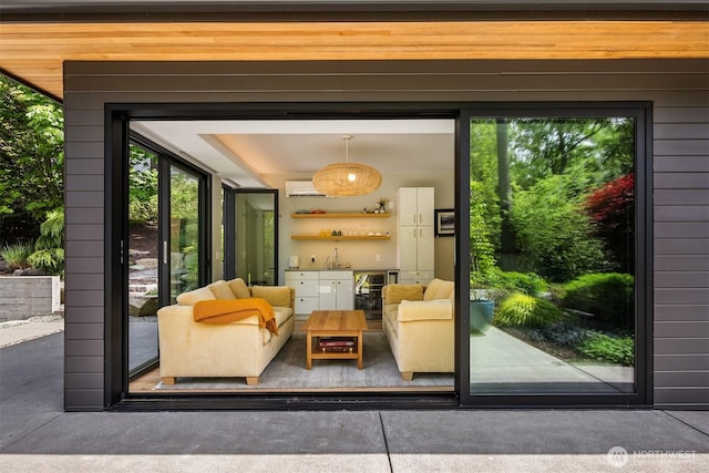 11012 Skinner Rd NE, Bainbridge Island, WA 98110 - doorway to outside featuring a dry bar, beverage cooler, concrete floors, and a wall mounted air conditioner