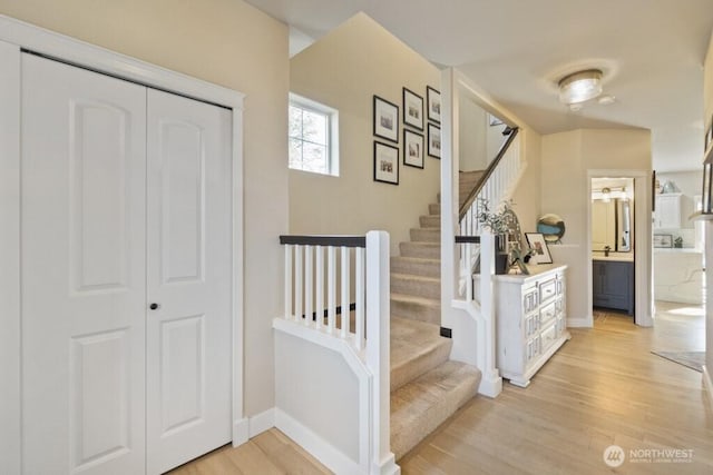 stairway featuring baseboards and wood finished floors