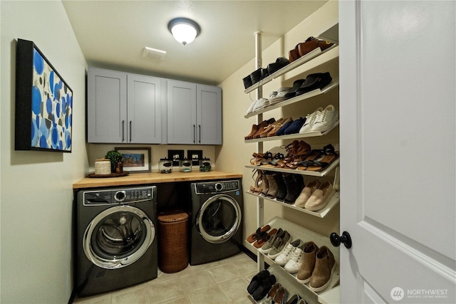 laundry area featuring washer and clothes dryer and cabinet space