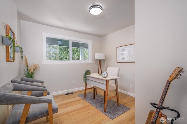 office area featuring light wood-style flooring and baseboards