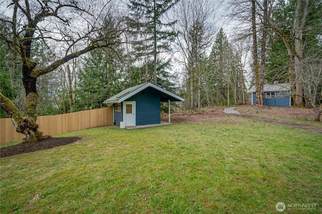 view of yard with an outdoor structure and a storage shed