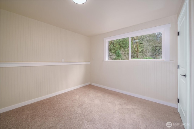 spare room with carpet and baseboards