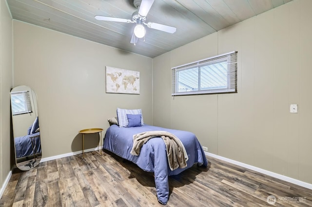 bedroom featuring wooden ceiling, wood finished floors, baseboards, and ceiling fan