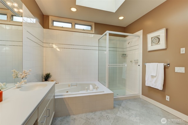 bathroom with baseboards, a jetted tub, a stall shower, and vanity