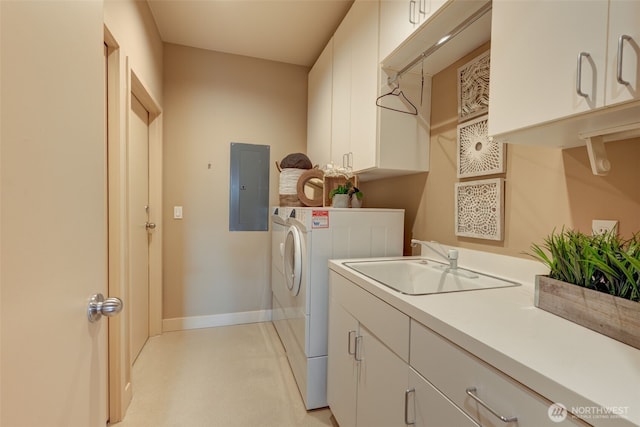 washroom featuring baseboards, washing machine and clothes dryer, electric panel, cabinet space, and a sink