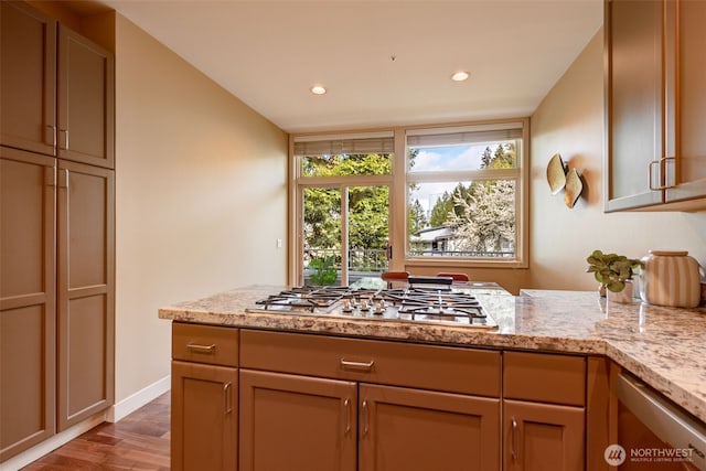 kitchen with baseboards, light stone countertops, stainless steel gas cooktop, recessed lighting, and wood finished floors