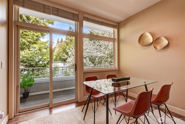 dining space featuring wood finished floors and baseboards