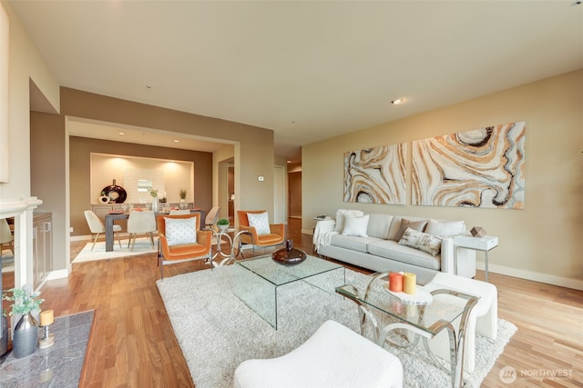 living room featuring baseboards and light wood-style flooring