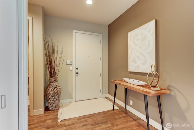 entrance foyer featuring light wood-style floors and baseboards