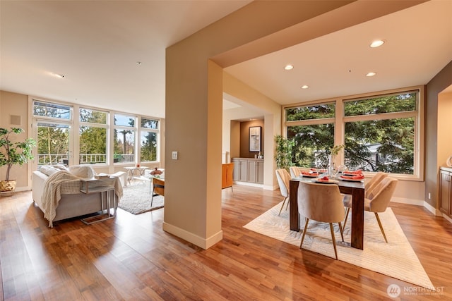 dining space with recessed lighting, baseboards, and light wood finished floors
