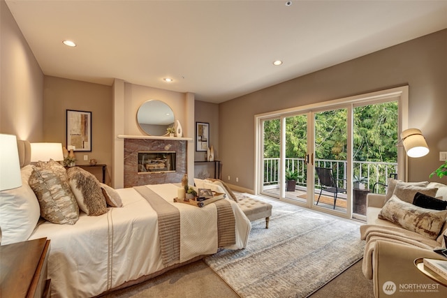 bedroom featuring a high end fireplace, access to exterior, recessed lighting, and carpet floors