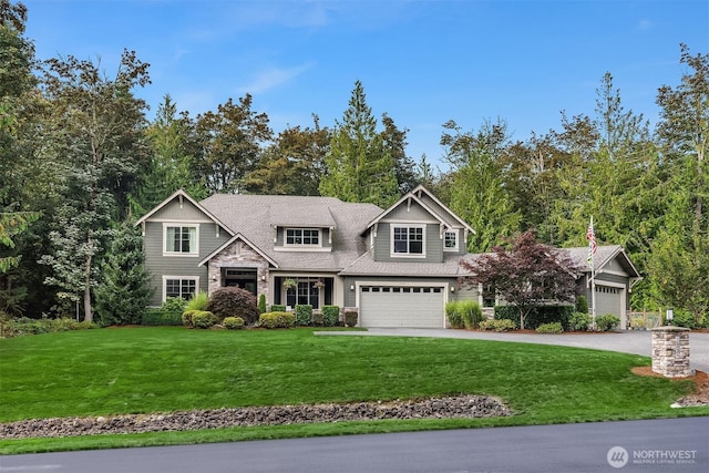 view of front of property with driveway, a shingled roof, a front lawn, a garage, and stone siding