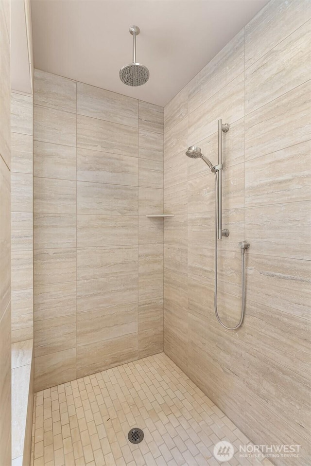 bathroom with a tile shower