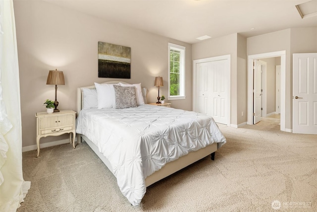 bedroom with baseboards, a closet, and light carpet