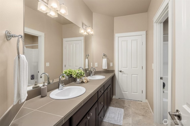 full bath featuring a sink, washtub / shower combination, and double vanity
