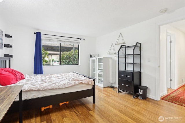 705 NE 143rd Ave Unit A1, Bellevue, WA 98007 - bedroom featuring baseboards and wood finished floors