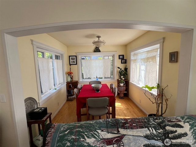 dining area featuring light wood-style flooring and baseboards