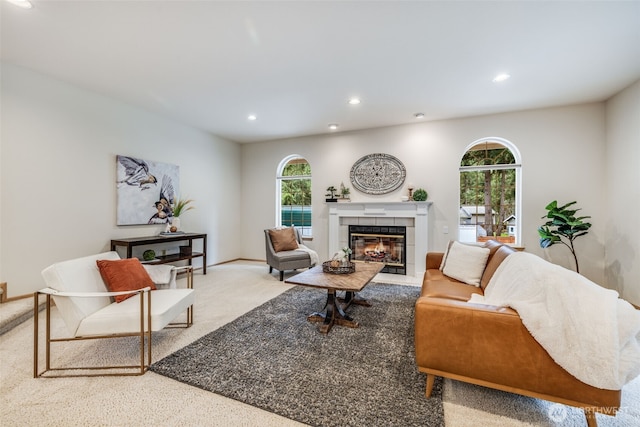 living area featuring baseboards, a fireplace, and recessed lighting