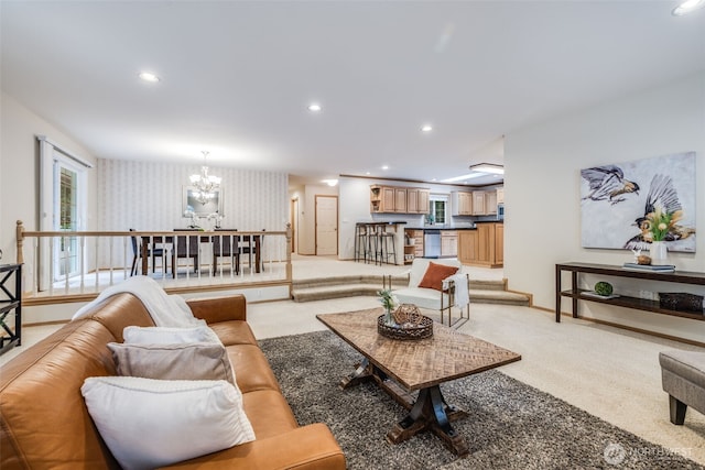 living area with baseboards, wallpapered walls, recessed lighting, light carpet, and an inviting chandelier
