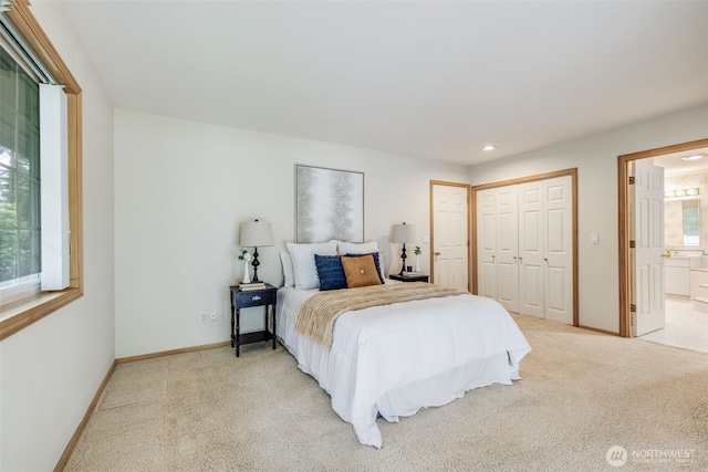bedroom with light carpet, baseboards, ensuite bathroom, and recessed lighting