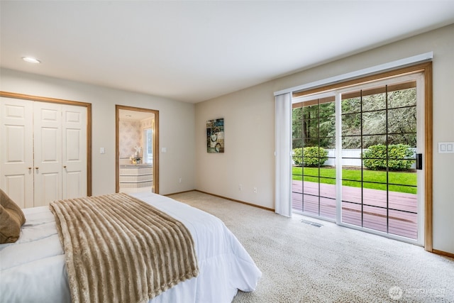 carpeted bedroom with a closet, visible vents, baseboards, connected bathroom, and access to outside