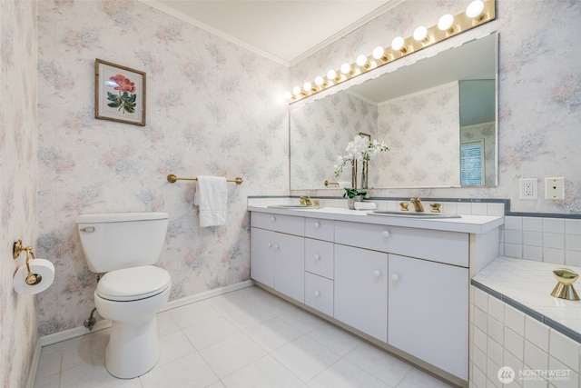 full bathroom featuring toilet, baseboards, wallpapered walls, a sink, and tile patterned floors