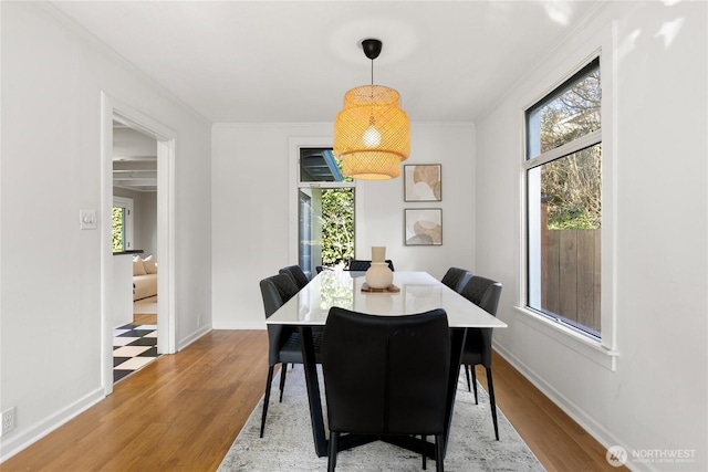 4712 S Angeline St, Seattle, WA 98118 - dining area with baseboards, wood finished floors, and crown molding