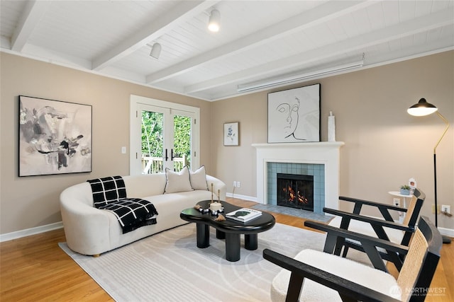 4712 S Angeline St, Seattle, WA 98118 - living room with baseboards, a tiled fireplace, beamed ceiling, wood ceiling, and wood finished floors
