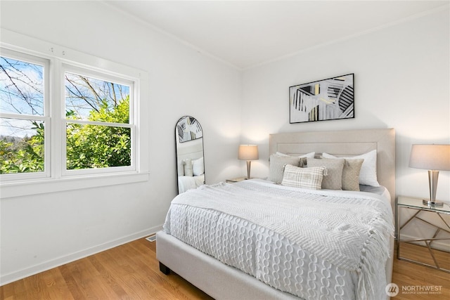 4712 S Angeline St, Seattle, WA 98118 - bedroom with baseboards, wood finished floors, and crown molding