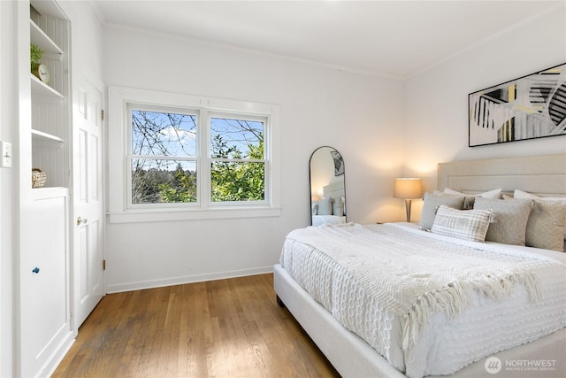 4712 S Angeline St, Seattle, WA 98118 - bedroom with ornamental molding, baseboards, and wood finished floors