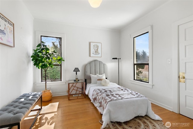 4712 S Angeline St, Seattle, WA 98118 - bedroom with baseboards, radiator, wood finished floors, and crown molding