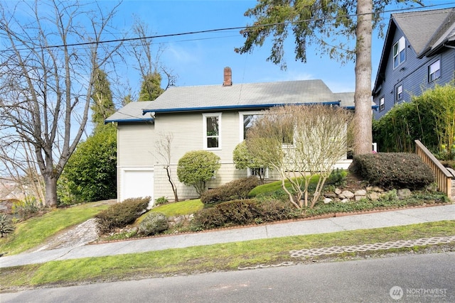 4712 S Angeline St, Seattle, WA 98118 - view of side of property with a garage and a chimney