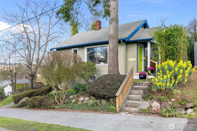 4712 S Angeline St, Seattle, WA 98118 - view of front of house with a chimney and a shingled roof