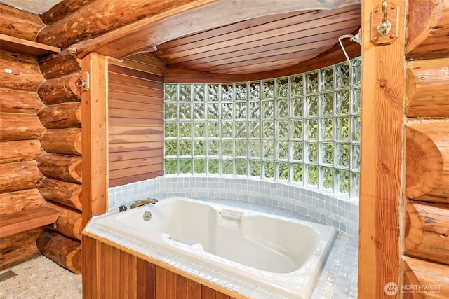 full bath with rustic walls, wooden ceiling, and a bath