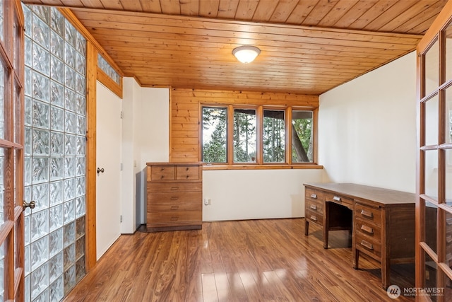 unfurnished office featuring wood finished floors and wood ceiling