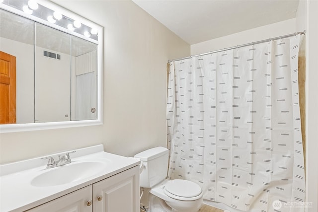 bathroom with visible vents, toilet, vanity, and a shower with curtain