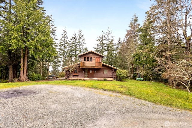 view of front of house with a front yard and log exterior