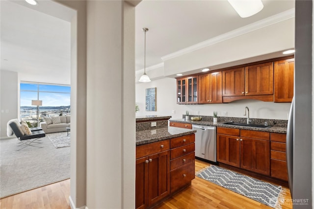 kitchen featuring a sink, stainless steel dishwasher, light wood-style floors, crown molding, and glass insert cabinets