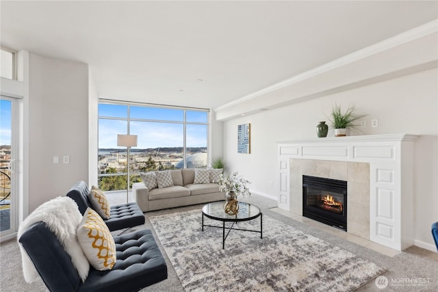 carpeted living area featuring expansive windows, baseboards, and a fireplace